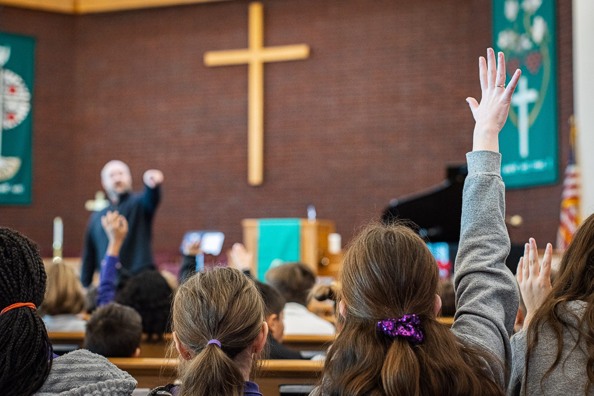 child raising hand in a christian school